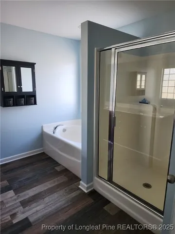 a bathroom with a bathtub and shower