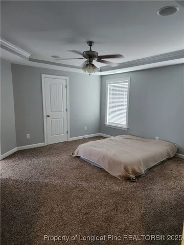 a view of a livingroom with a ceiling fan and window