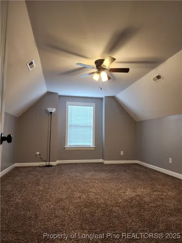 an empty room with a ceiling fan and a window