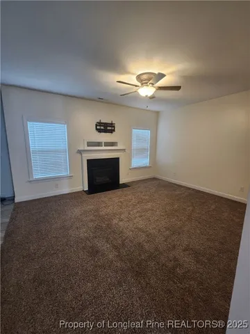 a view of empty room with a fireplace