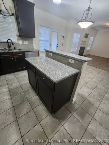 a kitchen with stainless steel appliances granite countertop a sink and cabinets