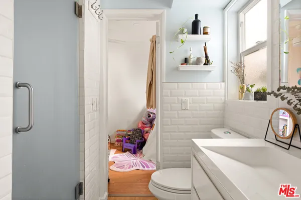 a bathroom with a sink a toilet and shower curtain