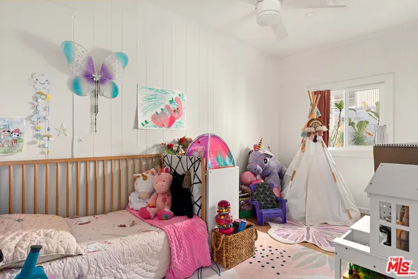 a bedroom with bed and a window