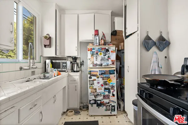 a kitchen with a sink appliances and cabinets