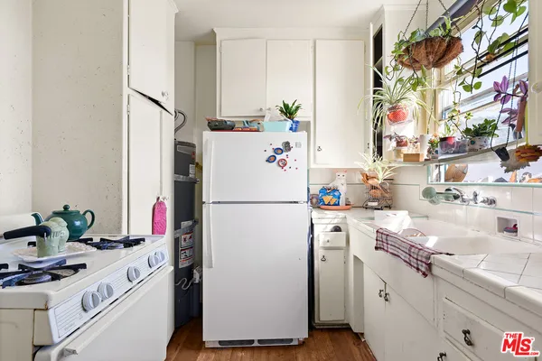 a white refrigerator freezer sitting inside of a kitchen