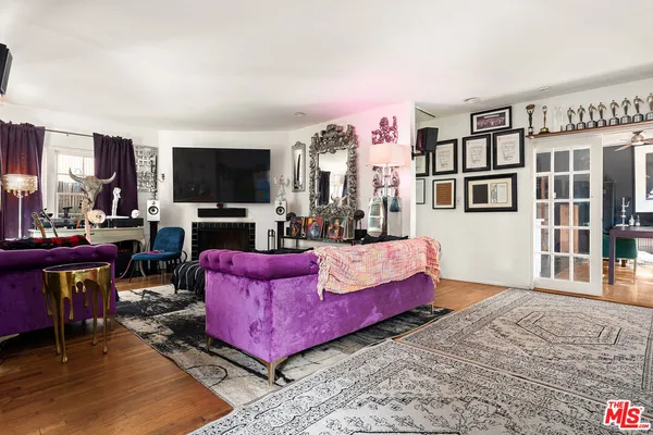 a living room with fireplace furniture and a flat screen tv