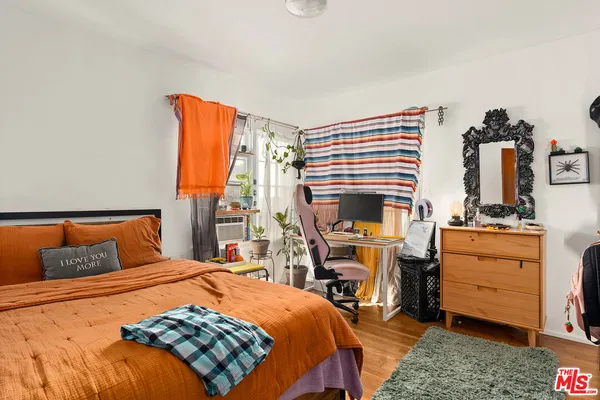 a bedroom with a bed and a dresser