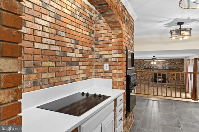 a kitchen with a refrigerator and a stove top oven