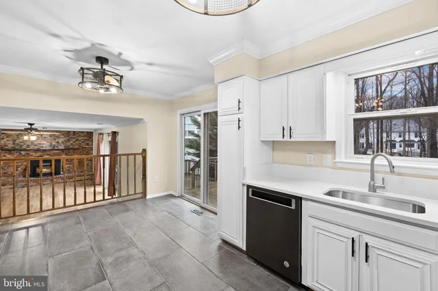 a view of a hallway with wooden floor and chandelier