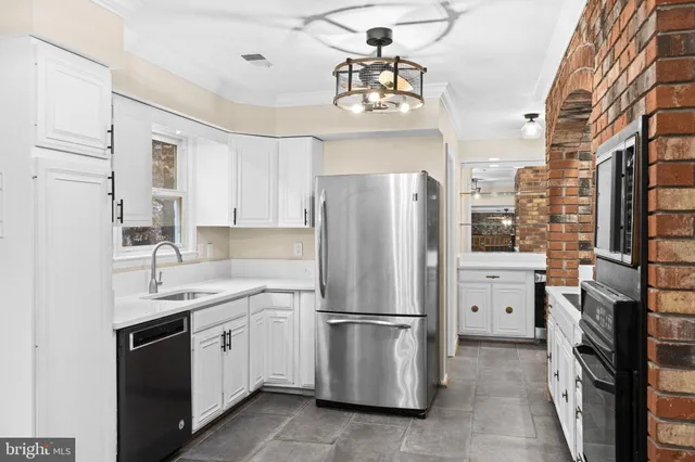 a view of a room with wooden floor fan and windows