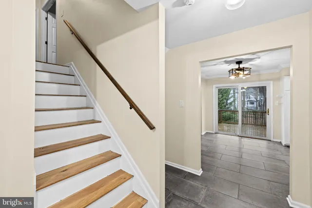 a bathroom with a granite countertop toilet a sink a mirror and a window