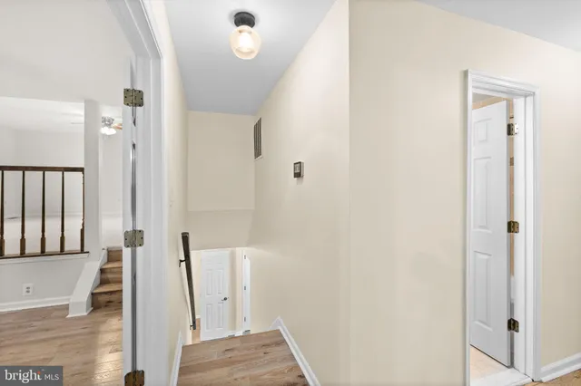 an empty room with furniture and chandelier