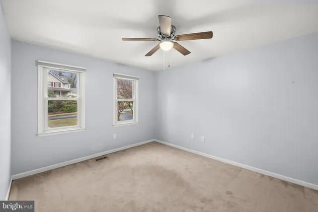 a view of a lake with boats and trees in the background