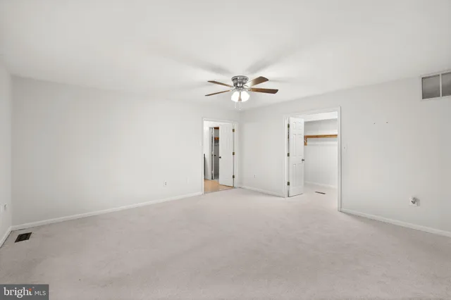 a front view of a house with a yard and a garage