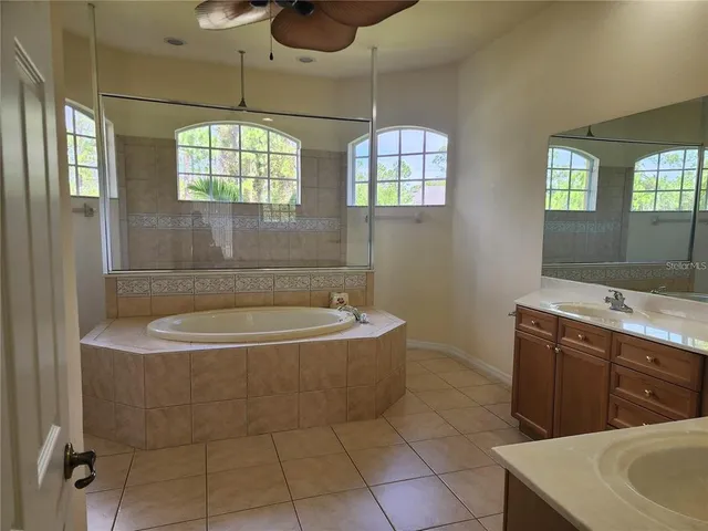 a bathroom with a sink a toilet a mirror and bathtub