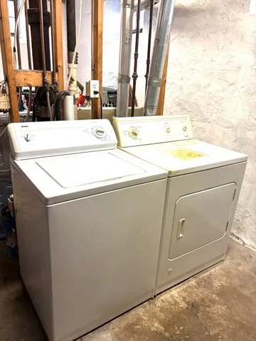 a balcony view with couple of cars parked on road