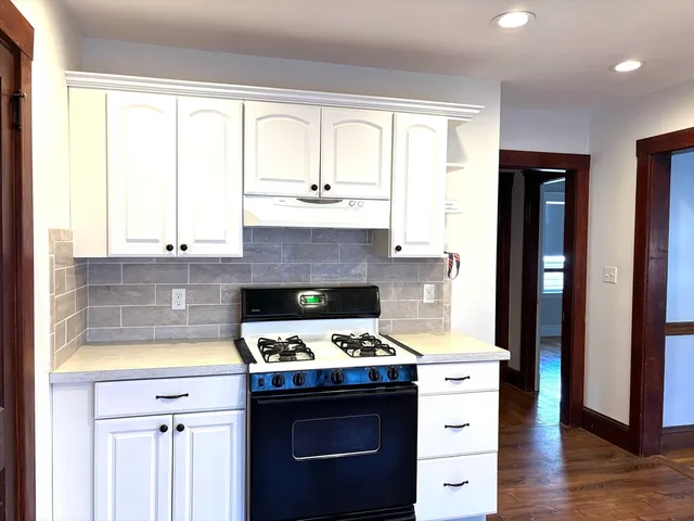 a kitchen with stainless steel appliances granite countertop a stove and a refrigerator