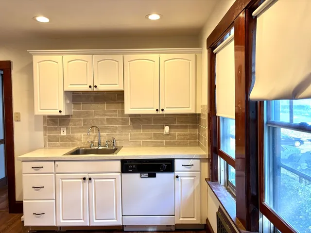 a kitchen with stainless steel appliances granite countertop a sink and cabinets