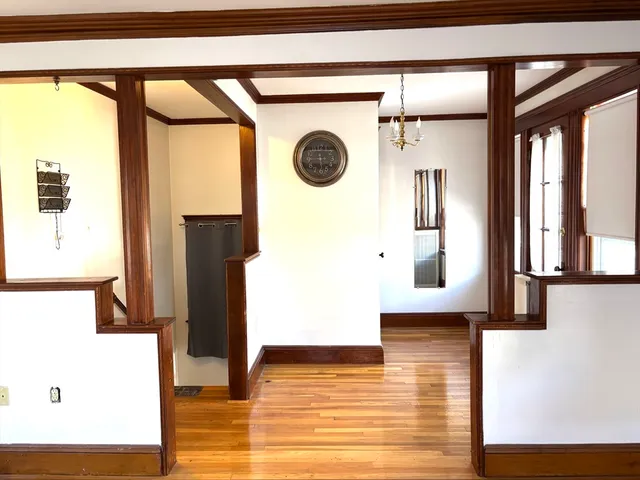 a living room with wooden floor and a window