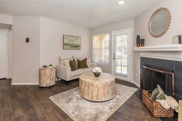 a living room with furniture and a fireplace