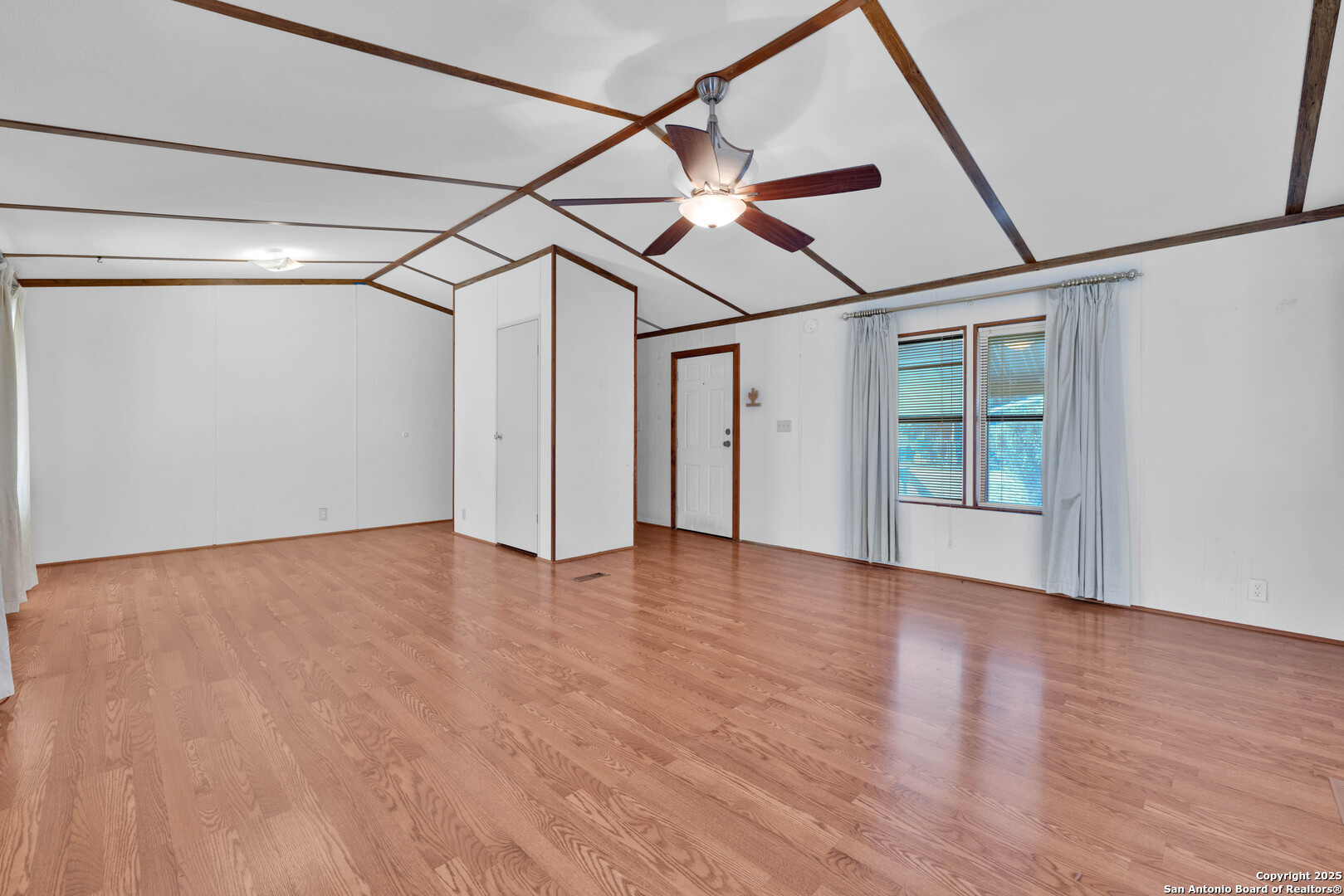 36 Retama Road Brackettville, TX 78832 - Photo 16 of 36 a view of a big room with wooden floor and windows
