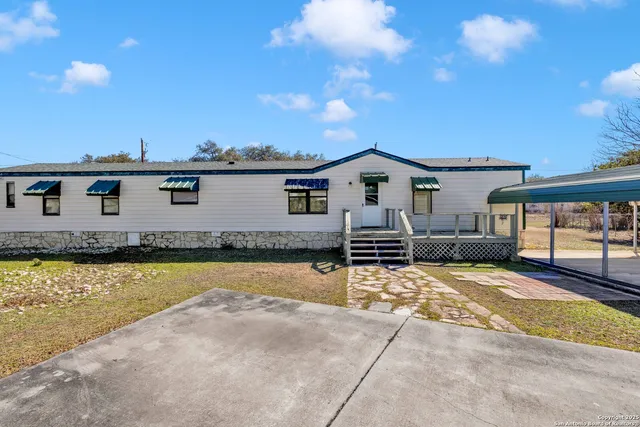 a view of a house with swimming pool and sitting area