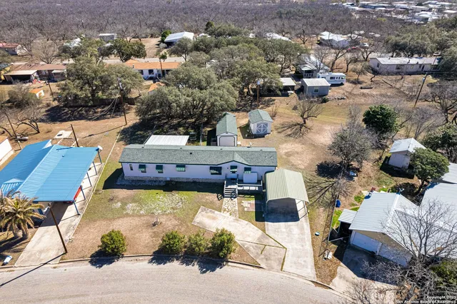 an aerial view of a house with a yard