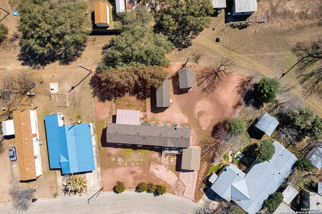 an aerial view of a house with a yard