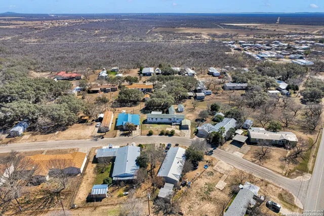 an aerial view of residential houses with outdoor space
