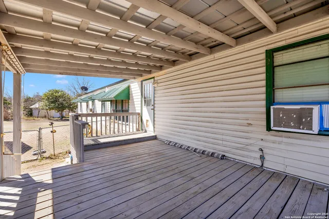 a view of a porch with wooden floor