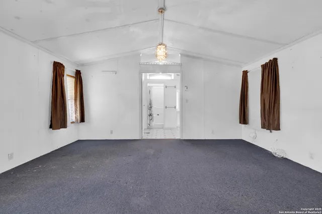 an empty room with windows and entrance