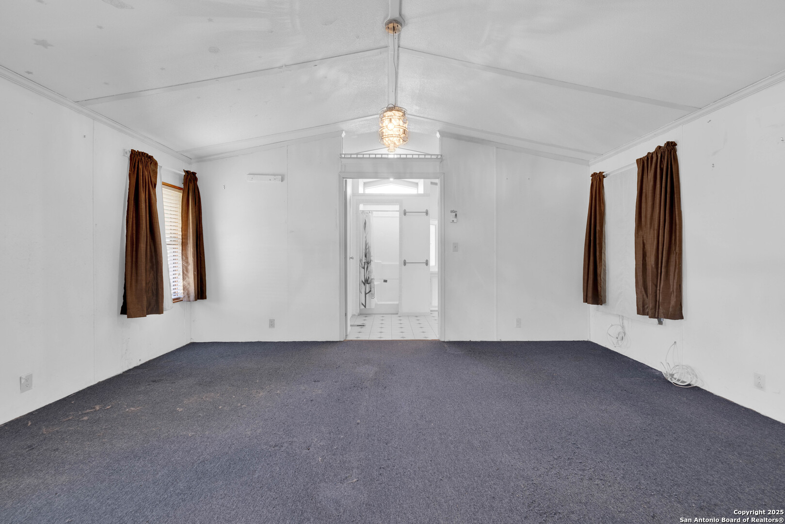 36 Retama Road Brackettville, TX 78832 - Photo 7 of 36 an empty room with windows and entrance