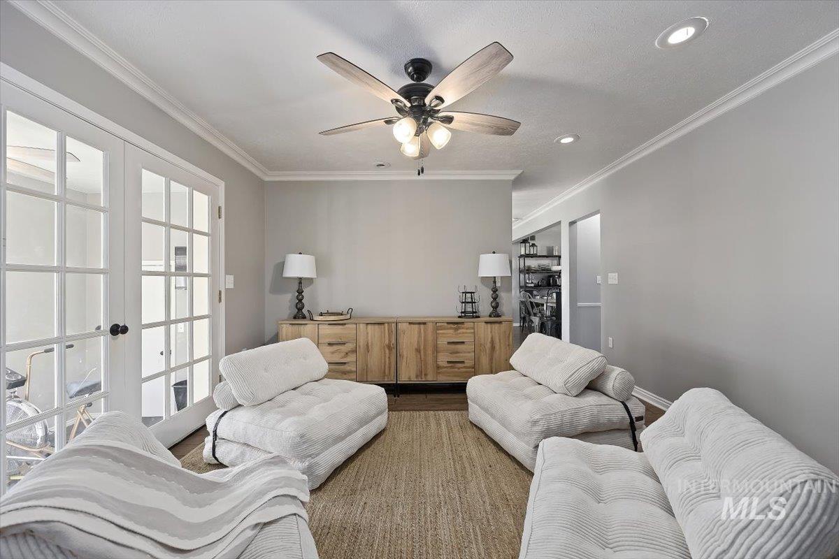 899 East 500th Street South Declo, ID 83323 - Photo 11 of 50 Living room with ornamental molding, french doors, dark wood finished floors, and a ceiling fan