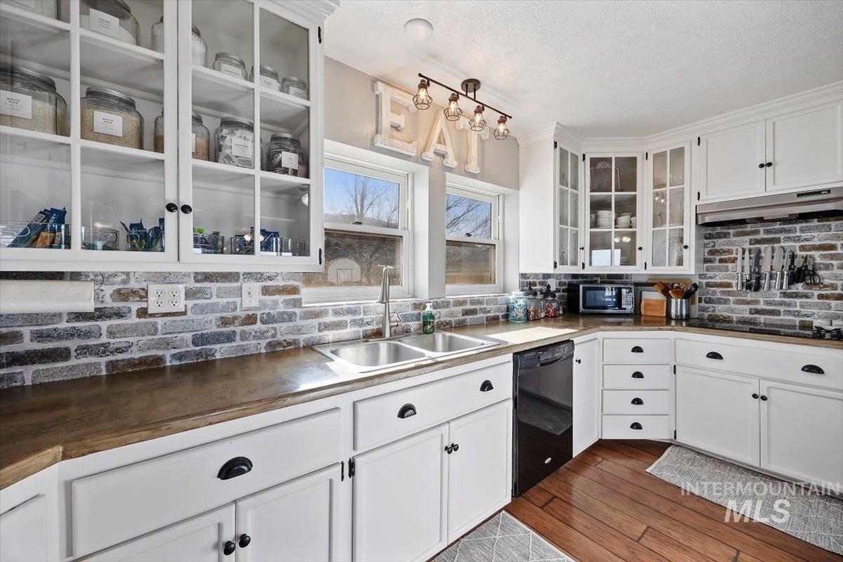 899 East 500th Street South Declo, ID 83323 - Photo 17 of 50 Kitchen featuring white cabinetry, glass fronted cabinets, black appliances, and dark wood finished floors