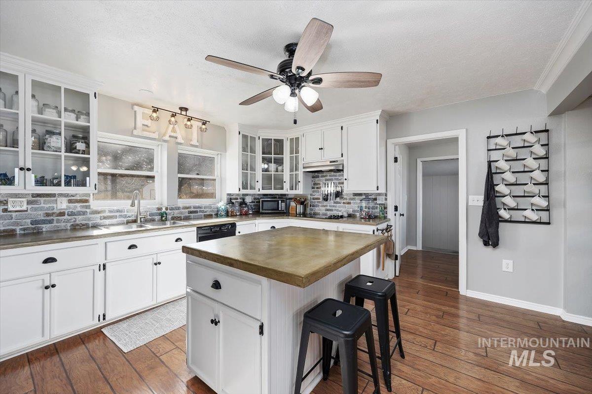 899 East 500th Street South Declo, ID 83323 - Photo 22 of 50 Kitchen featuring butcher block countertops, a breakfast bar area, white cabinetry, a kitchen island, and a ceiling fan
