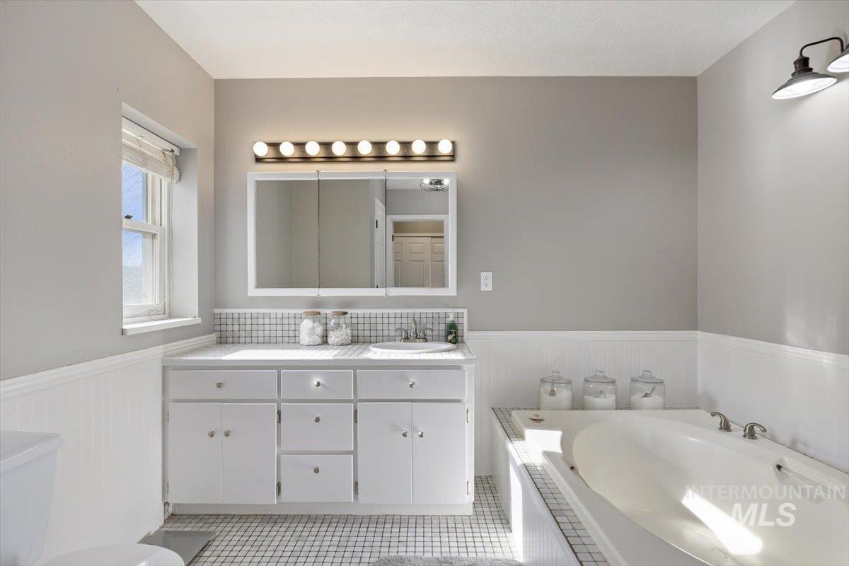 899 East 500th Street South Declo, ID 83323 - Photo 28 of 50 Bathroom with a wainscoted wall, vanity, and a garden tub