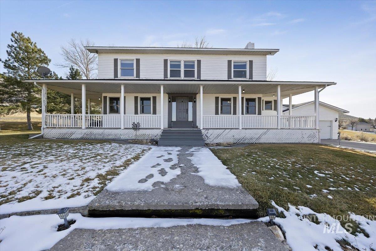 899 East 500th Street South Declo, ID 83323 - Photo 3 of 50 Farmhouse inspired home featuring a porch, a chimney, and a garage