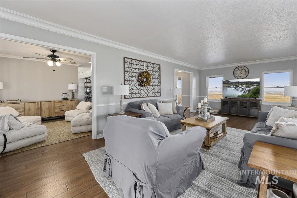 899 East 500th Street South Declo, ID 83323 - Photo 8 of 50 Living area with ornamental molding, hardwood / wood-style flooring, and a ceiling fan