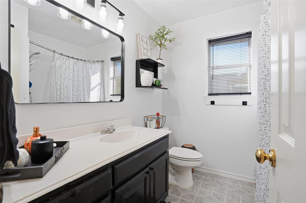 1970 Farm To Market Road 2264 Decatur, TX 76234 - Photo 13 of 27 a bathroom with a toilet a sink and mirror