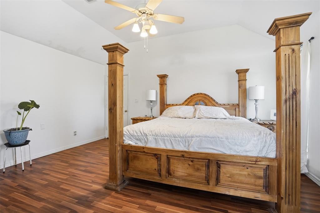 1970 Farm To Market Road 2264 Decatur, TX 76234 - Photo 16 of 27 a bedroom with a bed and a chandelier