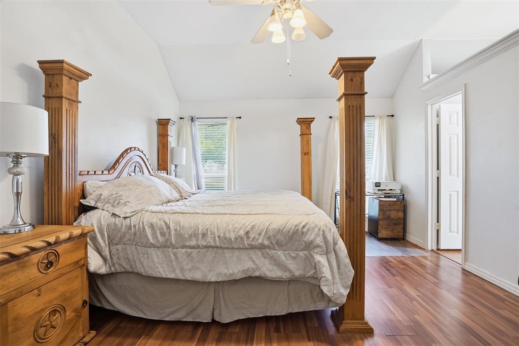 1970 Farm To Market Road 2264 Decatur, TX 76234 - Photo 17 of 27 a bedroom with a bed and a chandelier