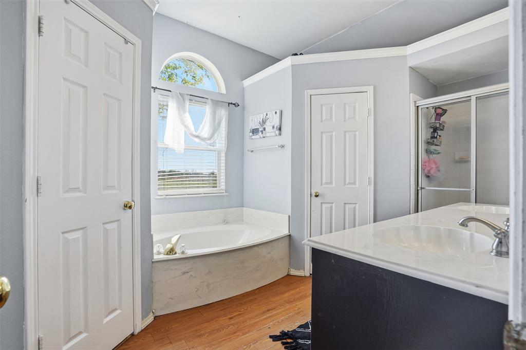 1970 Farm To Market Road 2264 Decatur, TX 76234 - Photo 18 of 27 a bathroom with a bathtub sink and mirror