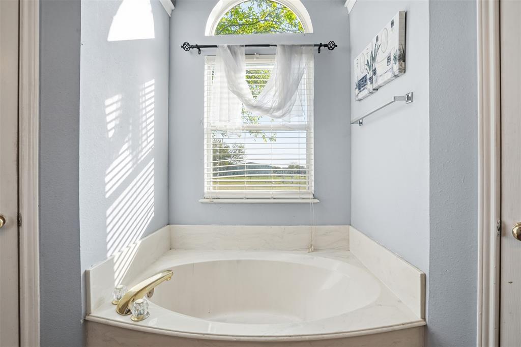 1970 Farm To Market Road 2264 Decatur, TX 76234 - Photo 20 of 27 a white bath tub sitting in a bathroom next to a window