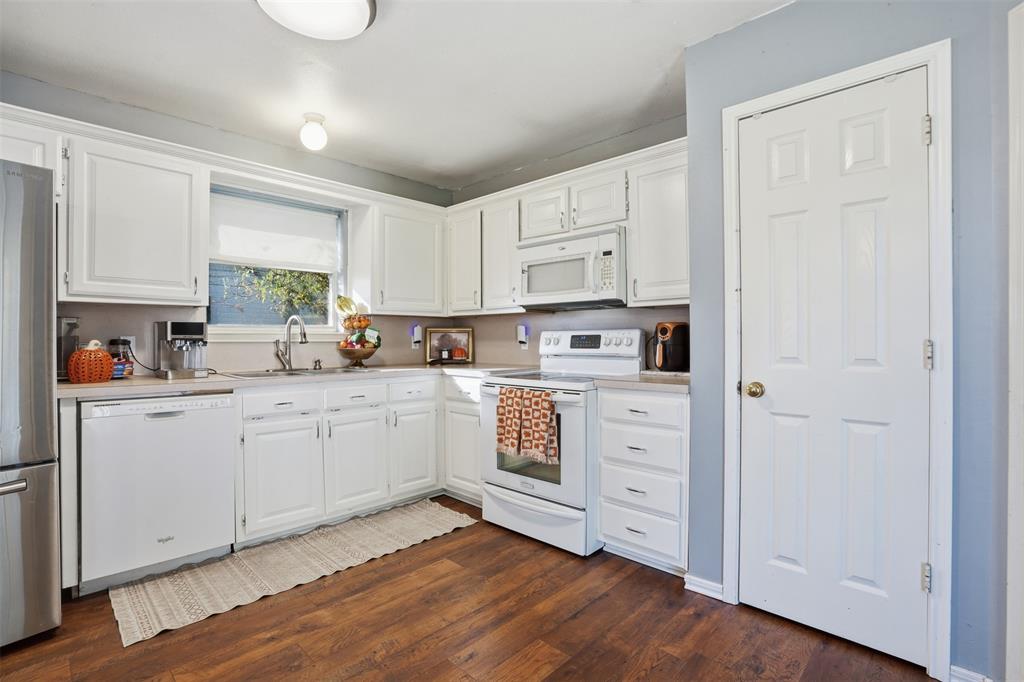 1970 Farm To Market Road 2264 Decatur, TX 76234 - Photo 9 of 27 a kitchen with white cabinets and white appliances