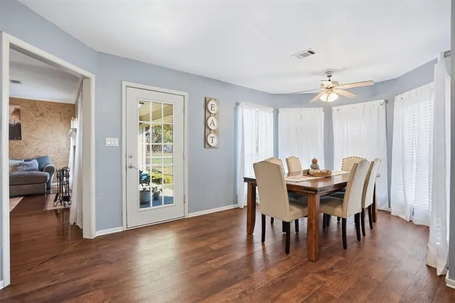 a view of a a dining room with furniture window and wooden floor