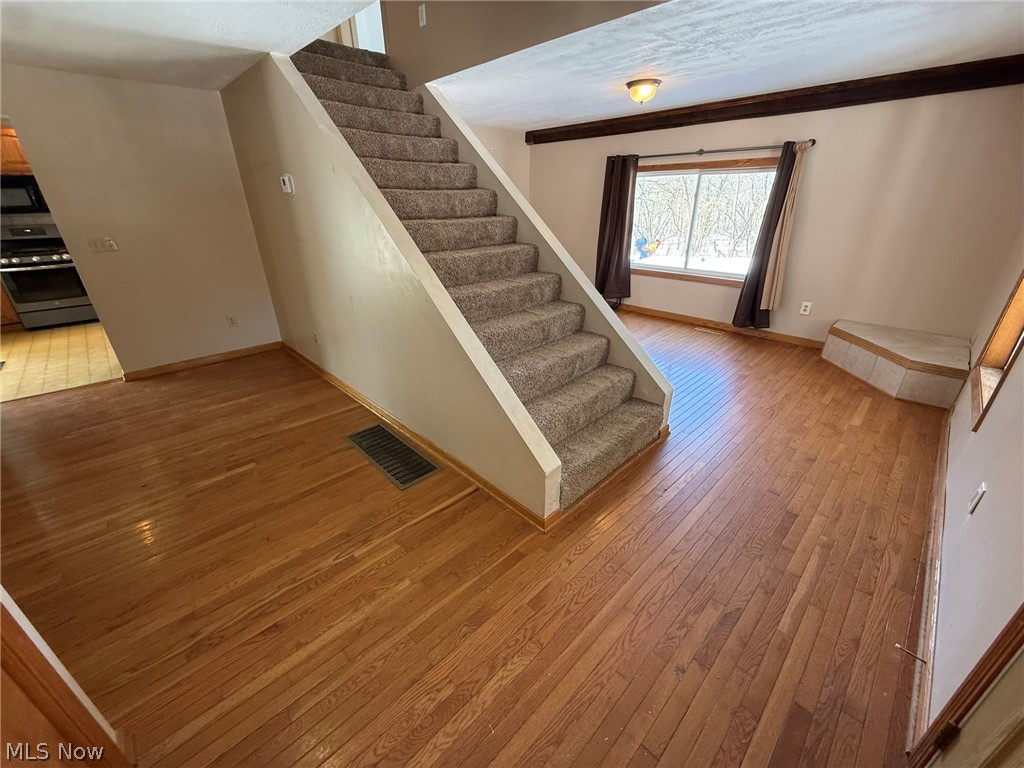 6784 Old Zoarville Road Northeast Dover, OH 44622 - Photo 5 of 50 Stairs with hardwood / wood-style flooring and baseboards