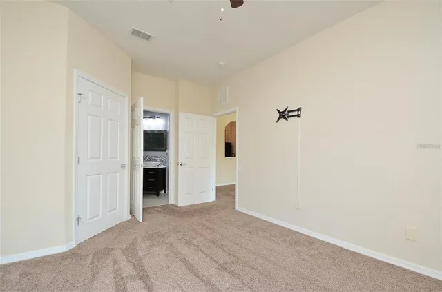 a view of an empty room with a cabinet