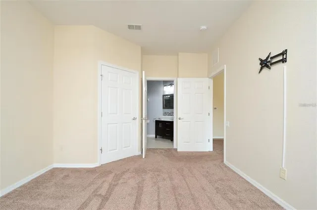 a view of a big room with closet and windows