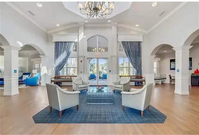 a living room with fireplace furniture and a large window