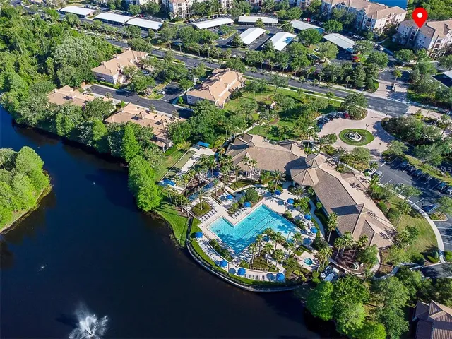 an aerial view of residential houses with outdoor space and trees all around